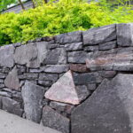 What is hardscaping? Explore this concept, which involves the use of non-living elements like pavers, stones, and structures to enhance outdoor spaces.